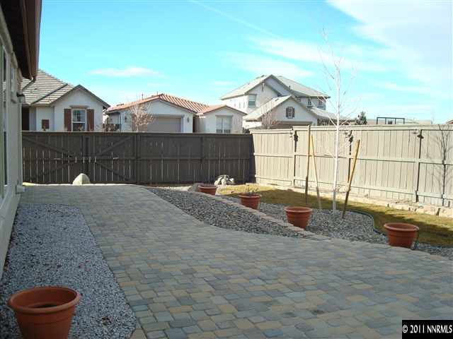 501 Martingale Court Reno, NV 89521 - Photo 12 of 13 a view of a white house next to a yard