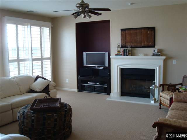 501 Martingale Court Reno, NV 89521 - Photo 3 of 13 a living room with furniture a flat screen tv and a fireplace