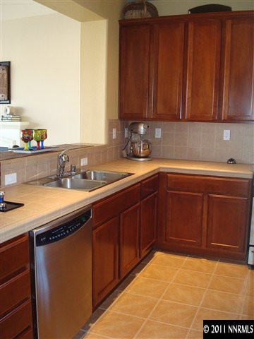 501 Martingale Court Reno, NV 89521 - Photo 4 of 13 a kitchen with a sink cabinets and utility