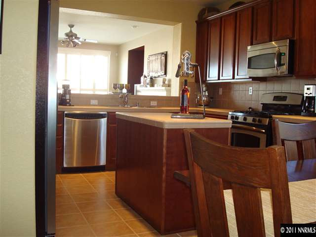 501 Martingale Court Reno, NV 89521 - Photo 6 of 13 a kitchen with stainless steel appliances granite countertop a stove a sink dishwasher and microwave