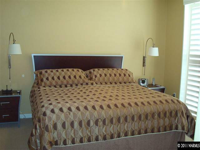 501 Martingale Court Reno, NV 89521 - Photo 10 of 13 a large bed sitting in a bedroom next to a window