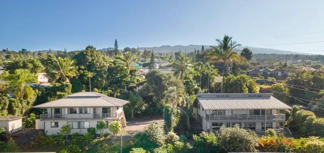 a front view of a building with a garden