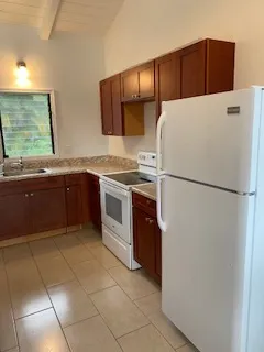 a kitchen with stainless steel appliances a refrigerator sink and cabinets