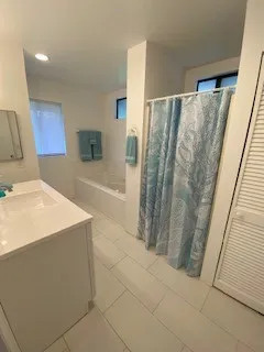 a bathroom with a bathtub and a shower