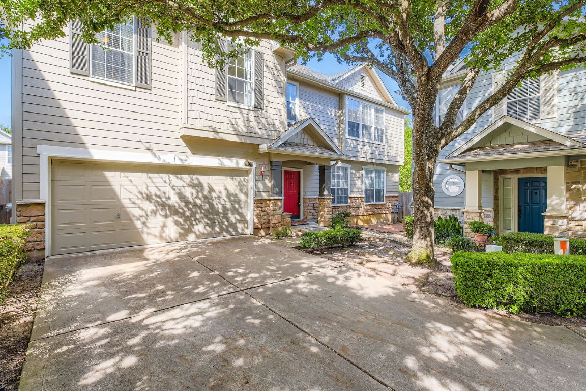 8518 Cahill Drive, Unit 20 Austin, TX 78729 - Photo 1 of 36 a front view of a house with a yard and potted plants