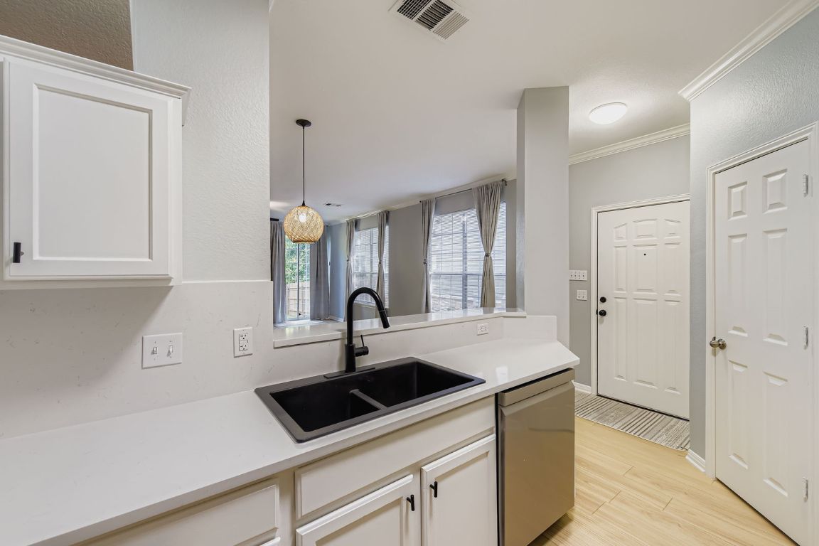 8518 Cahill Drive, Unit 20 Austin, TX 78729 - Photo 11 of 36 a kitchen with a sink and a refrigerator