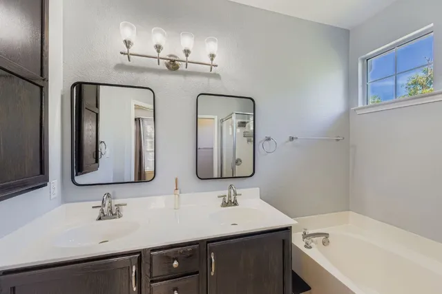 a bathroom with a double vanity sink and mirror