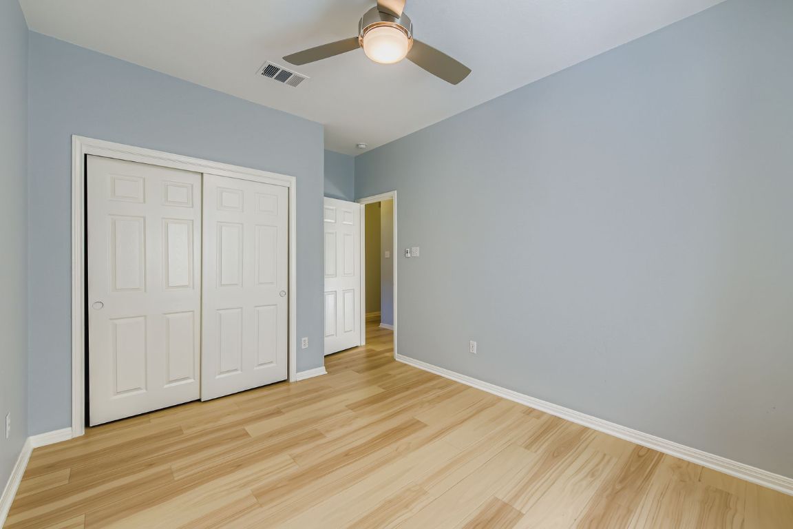8518 Cahill Drive, Unit 20 Austin, TX 78729 - Photo 20 of 36 a view of an empty room with wooden floor