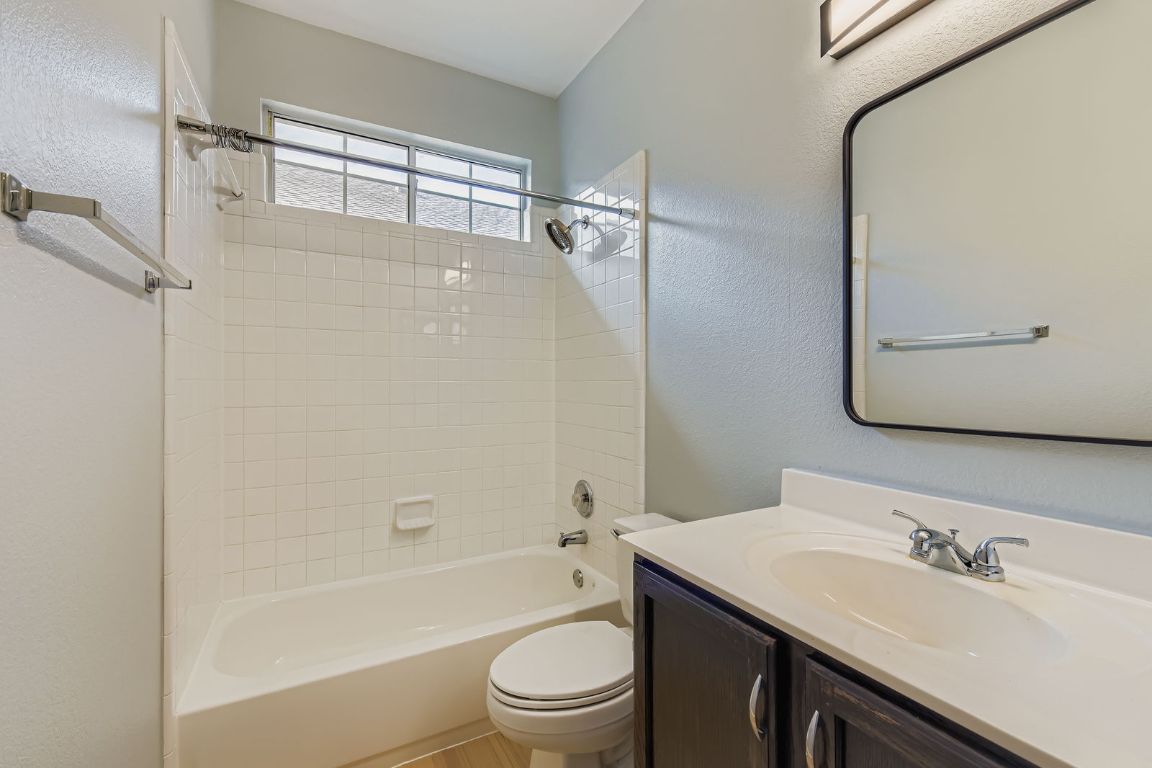 8518 Cahill Drive, Unit 20 Austin, TX 78729 - Photo 21 of 36 a bathroom with a granite countertop sink toilet and shower