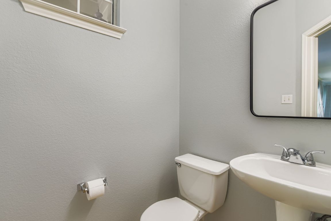 8518 Cahill Drive, Unit 20 Austin, TX 78729 - Photo 25 of 36 a white toilet sitting next to a bathroom sink