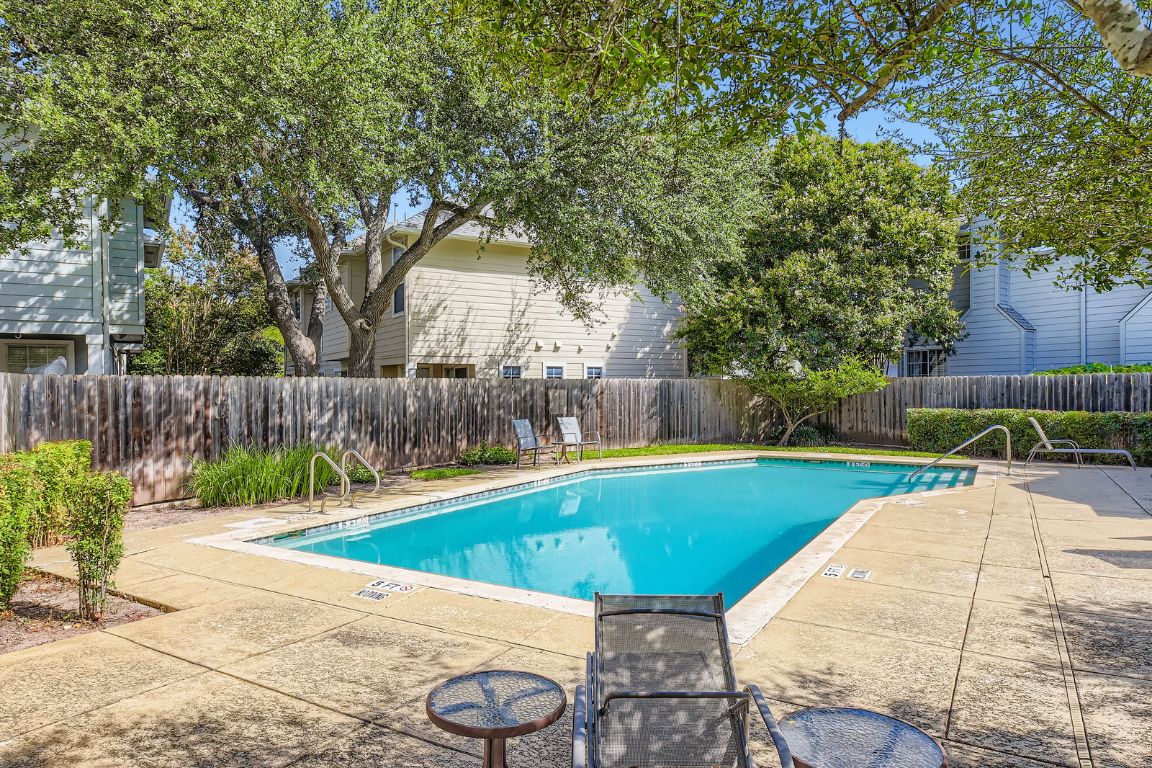 8518 Cahill Drive, Unit 20 Austin, TX 78729 - Photo 31 of 36 a view of a swimming pool with a patio and a yard