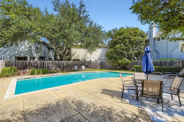 a view of a backyard with swimming pool