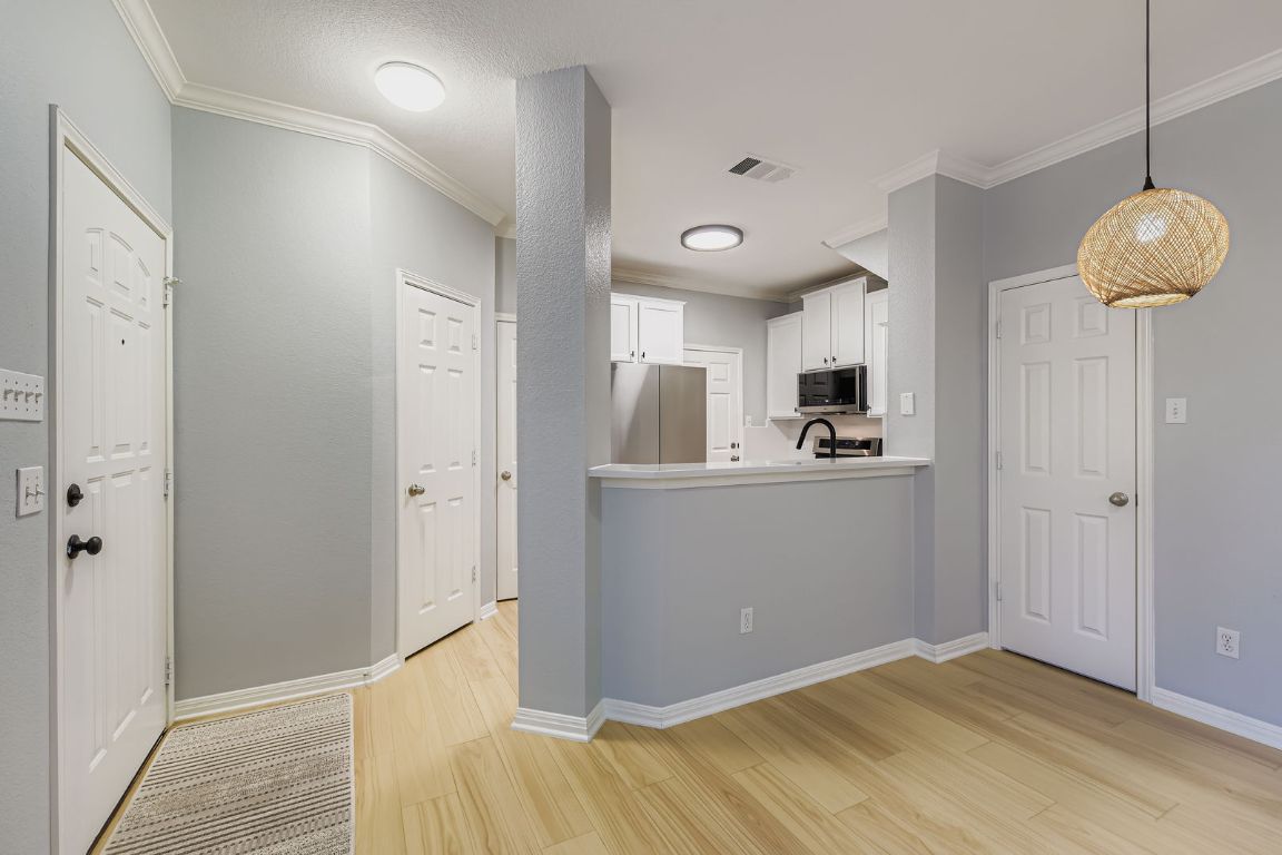 8518 Cahill Drive, Unit 20 Austin, TX 78729 - Photo 6 of 36 a view of a kitchen from the hallway