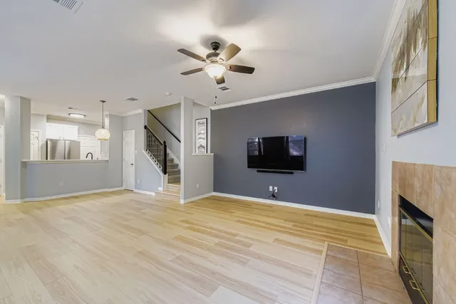 a view of a livingroom with a flat screen tv and kitchen view