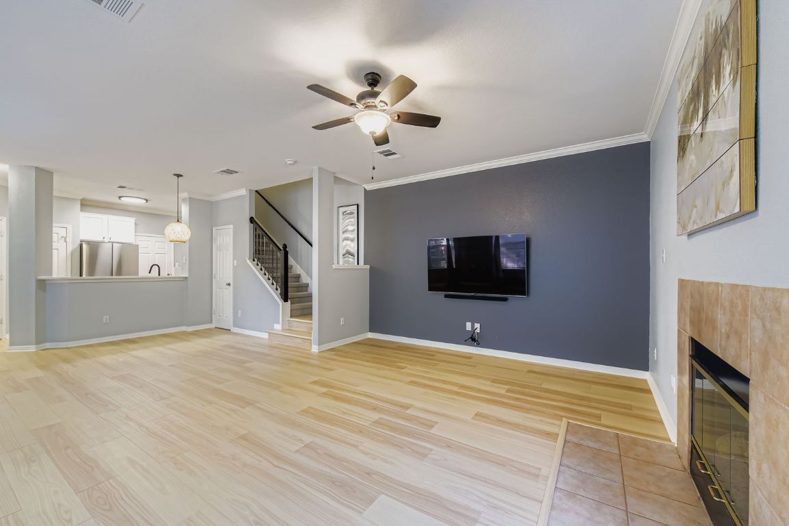 8518 Cahill Drive, Unit 20 Austin, TX 78729 - Photo 9 of 36 a view of a livingroom with a flat screen tv and kitchen view