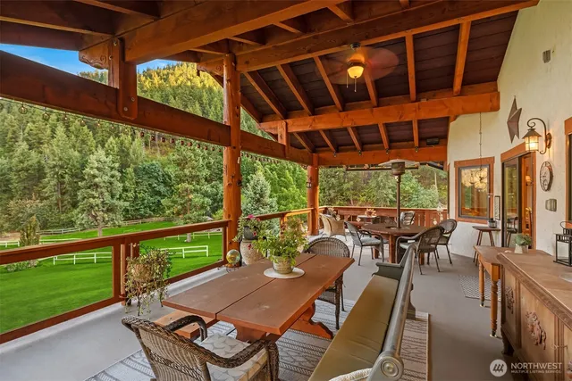 a kitchen with stainless steel appliances granite countertop a stove and a large window