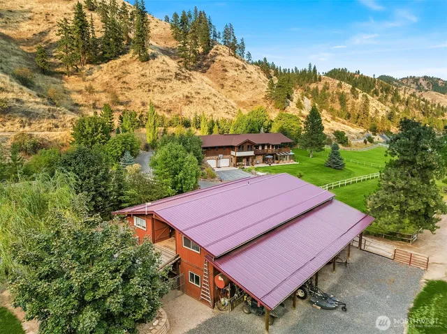 an aerial view of a house with yard