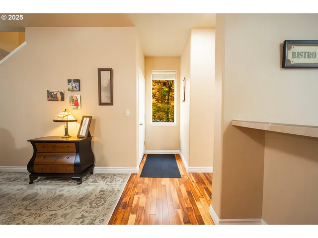 a view of hallway with furniture and a chandelier