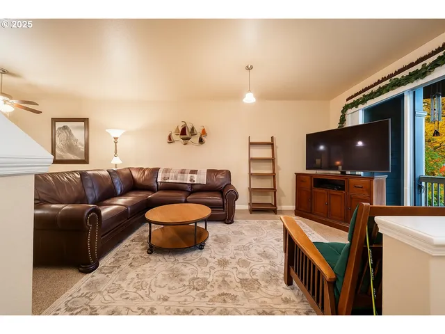 a kitchen with stainless steel appliances granite countertop a refrigerator a sink dishwasher and a stove