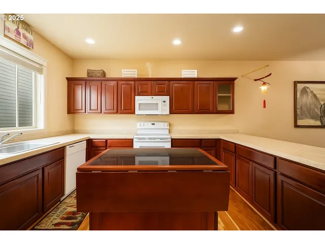 a kitchen with a refrigerator and a sink