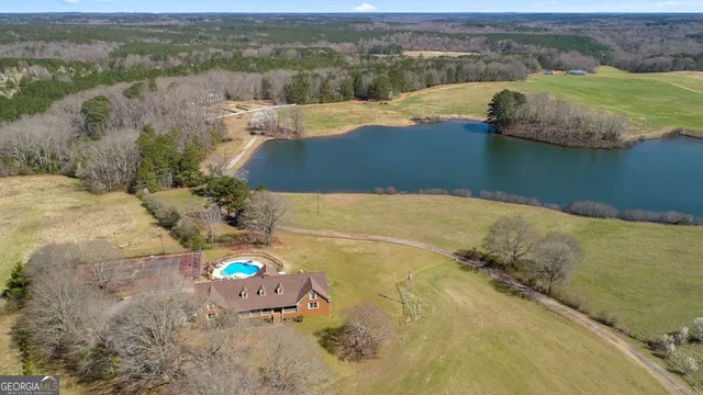 an aerial view of a house with a lake view