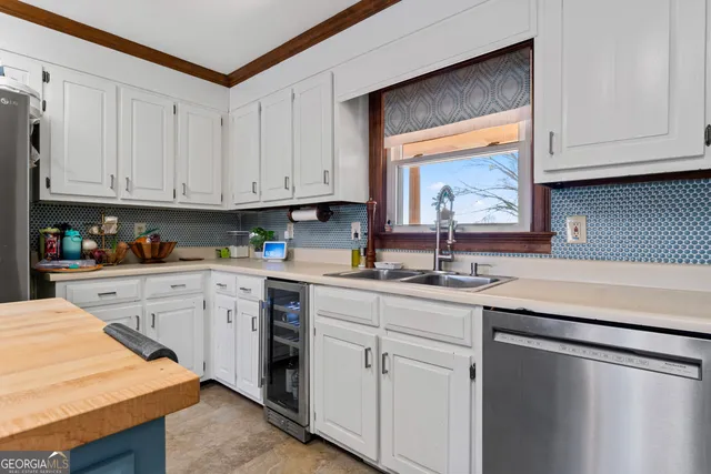 a kitchen with granite countertop white cabinets and white appliances
