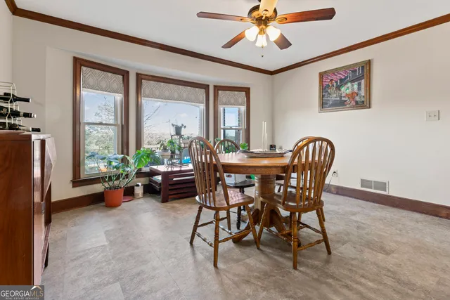a view of a dining room with furniture window and outside view