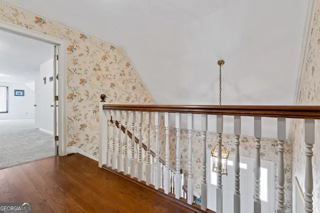 a view of a hallway with wooden floor and entryway