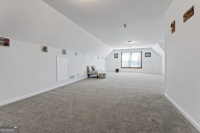 a view of a big room with closet and windows