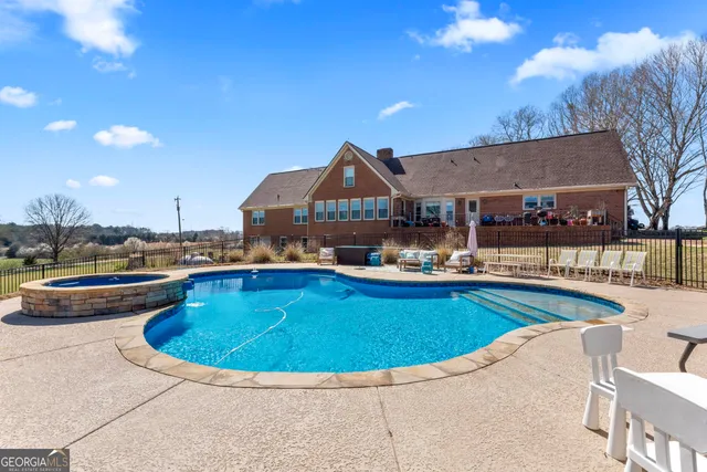a view of a swimming pool and lounge chairs