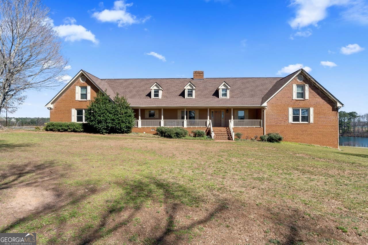 2940 East Lake Road McDonough, GA 30252 - Photo 4 of 47 a front view of a house with a yard