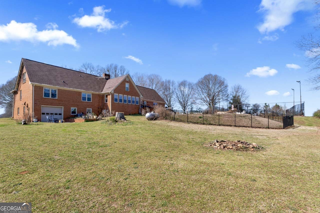 2940 East Lake Road McDonough, GA 30252 - Photo 41 of 47 a view of an house with backyard and a tree