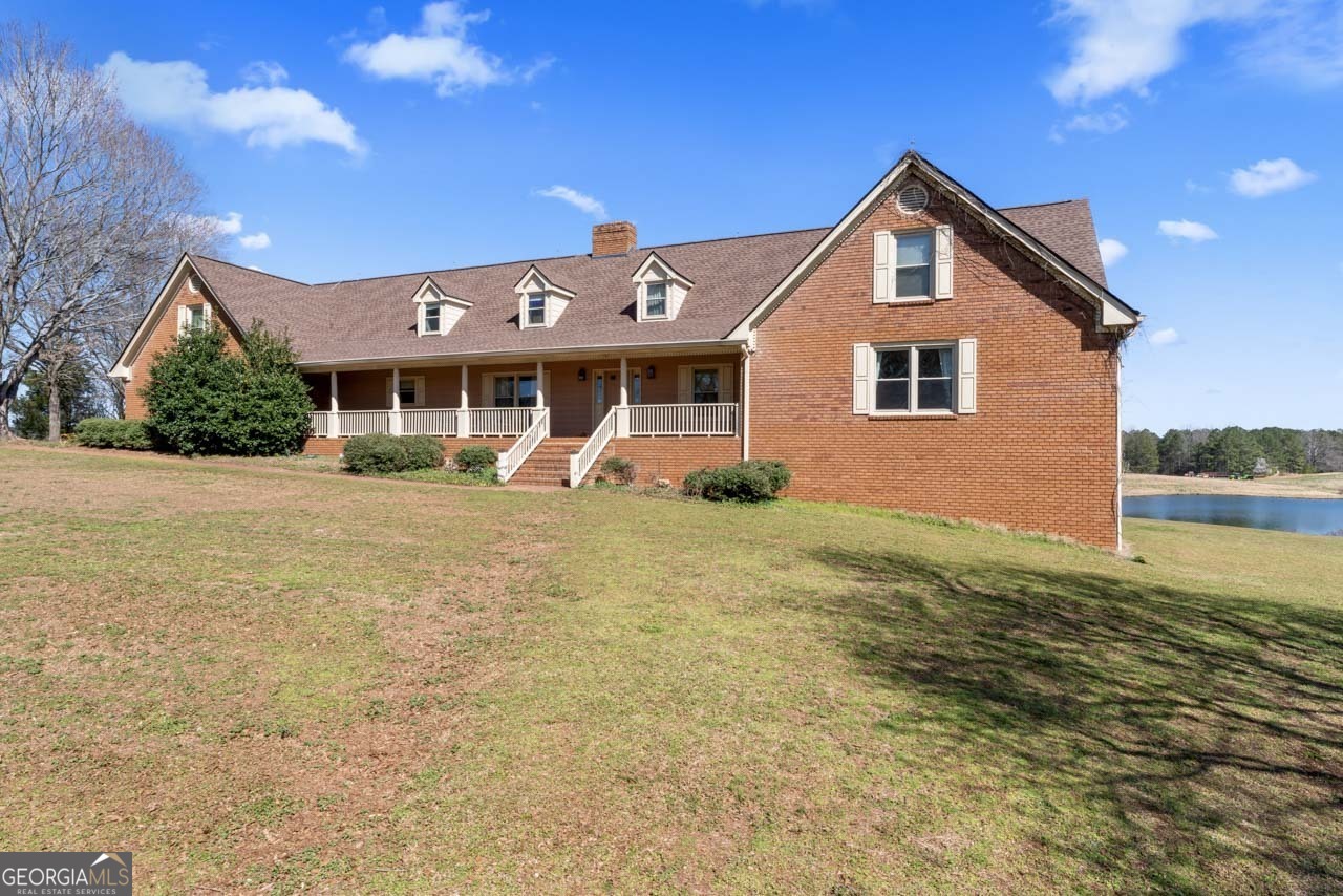 2940 East Lake Road McDonough, GA 30252 - Photo 42 of 47 a front view of a house with a yard and potted plants
