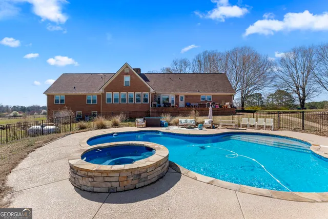 a swimming pool with outdoor seating and yard