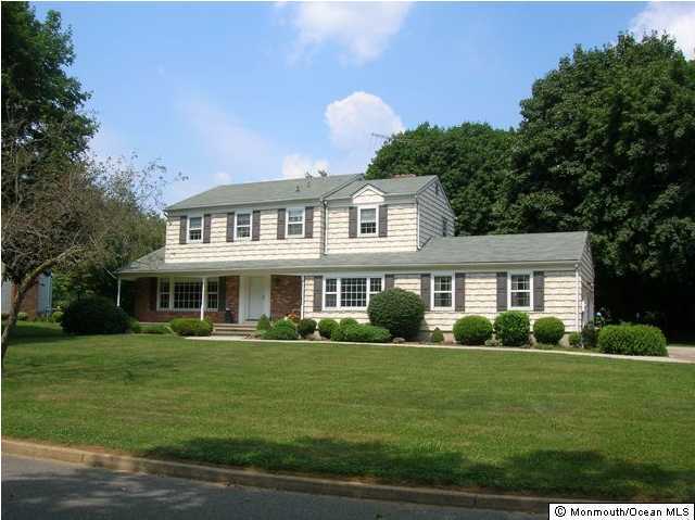 106 Ballantine Road Middletown, NJ 07748 - Photo 1 of 3 a front view of a house with a garden