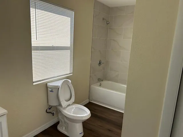 a bathroom with a sink a toilet and tub