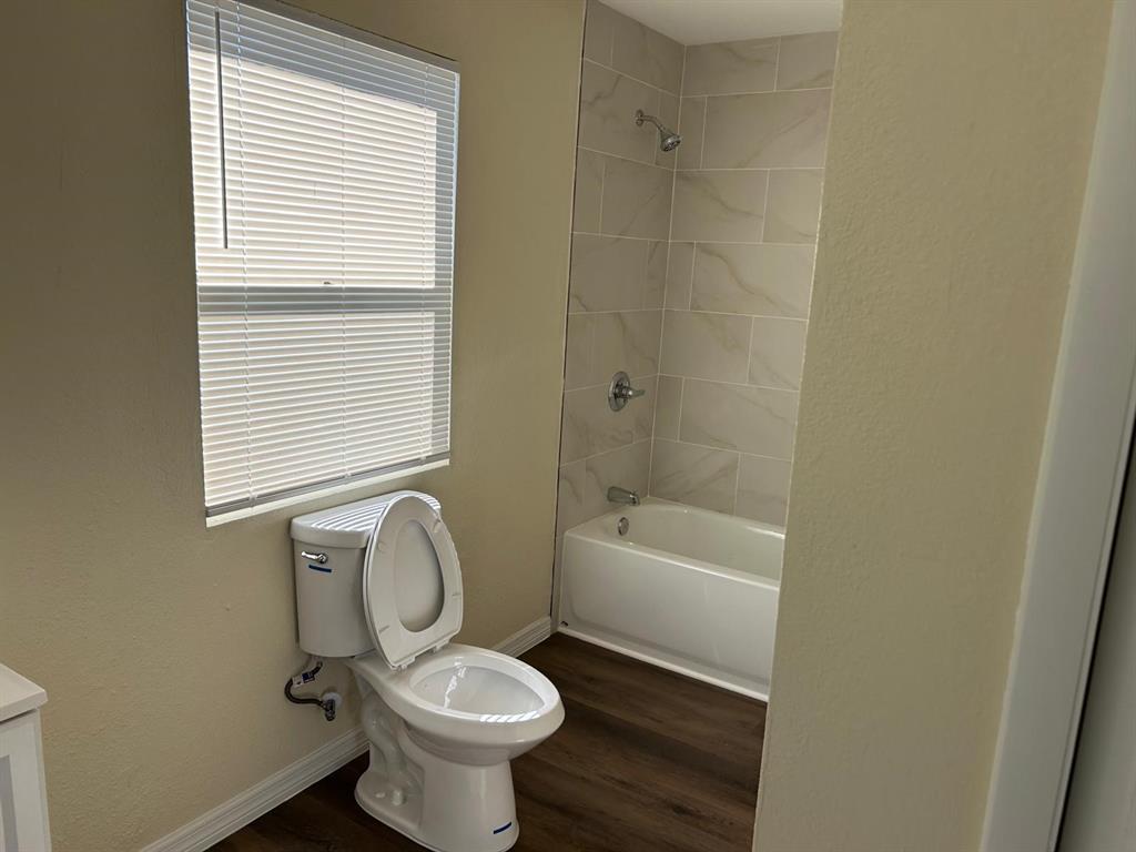 371 Banyan Avenue Pahokee, FL 33476 - Photo 11 of 17 a bathroom with a sink a toilet and tub