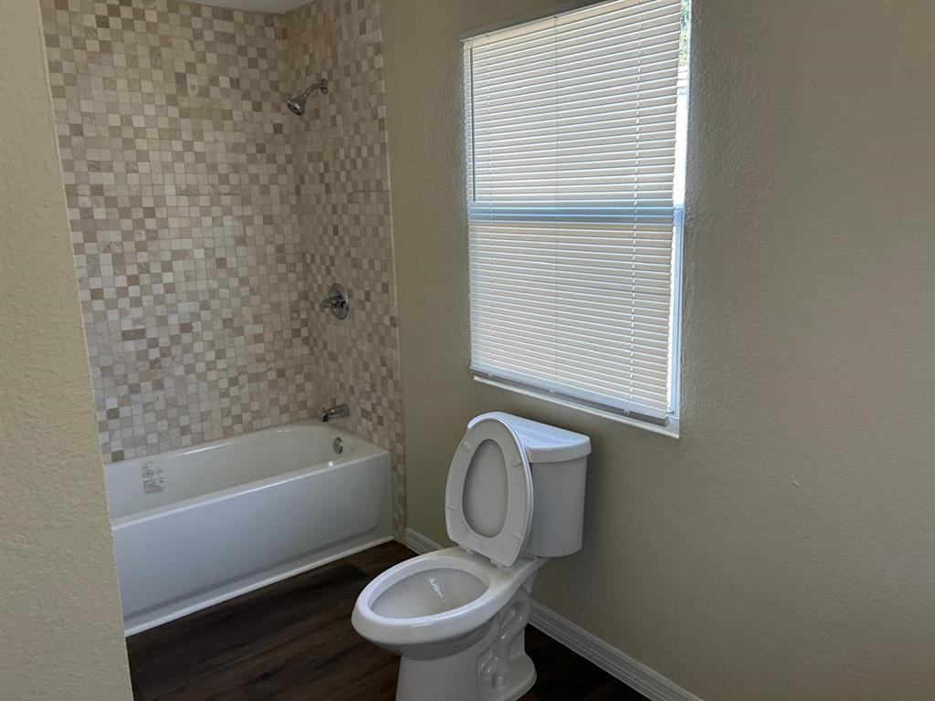 371 Banyan Avenue Pahokee, FL 33476 - Photo 4 of 17 a white toilet sitting next to a bath tub