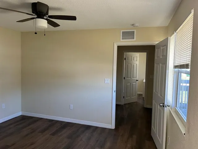 wooden floor in an empty room with a mirror