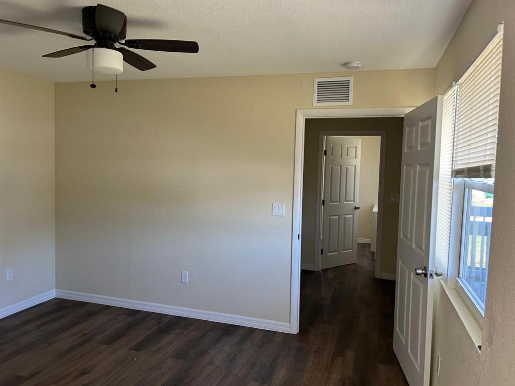 371 Banyan Avenue Pahokee, FL 33476 - Photo 9 of 17 wooden floor in an empty room with a mirror