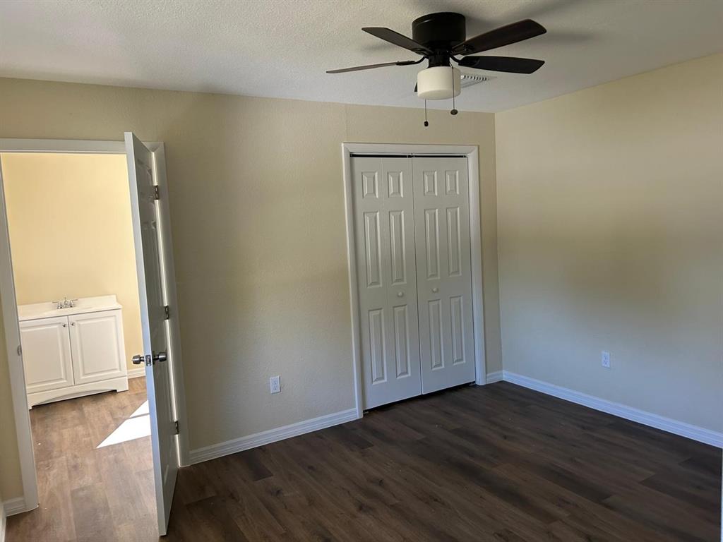 371 Banyan Avenue Pahokee, FL 33476 - Photo 10 of 17 a view of a livingroom with wooden floor and a ceiling fan