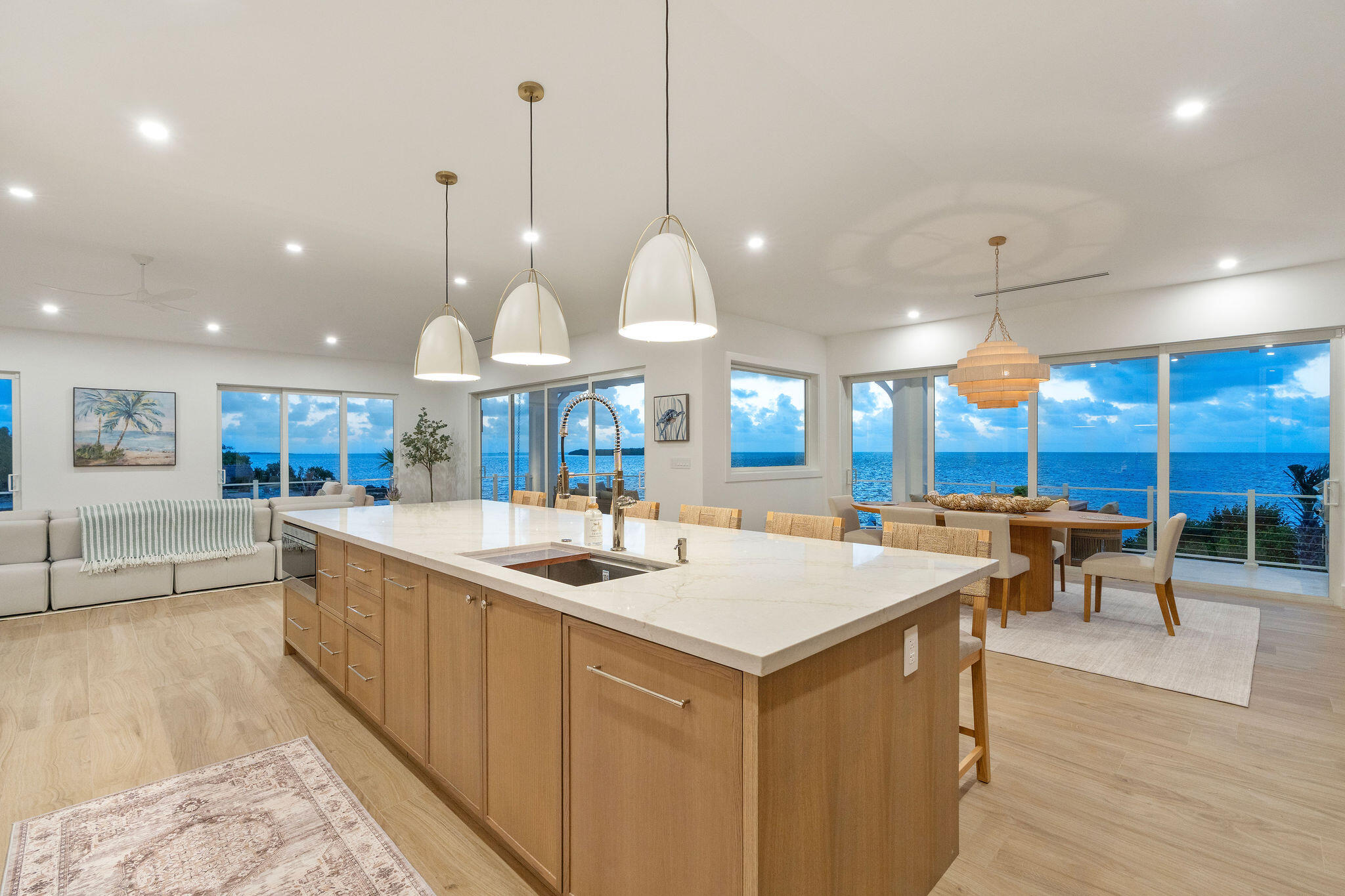 1002 Snapper Lane Key Largo, FL 33037 - Photo 7 of 106 a kitchen with stainless steel appliances granite countertop a sink a oven a dining table and chairs with wooden floor