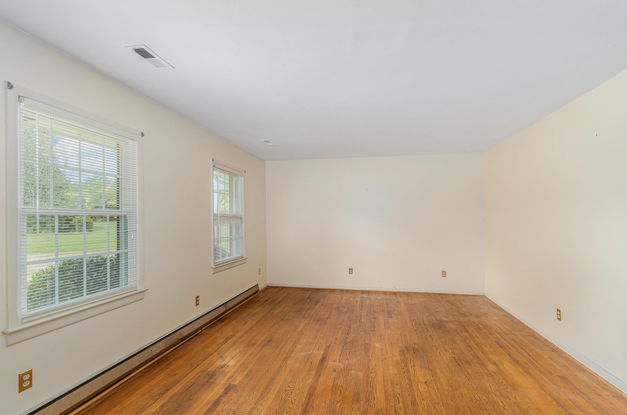 4800 Kyle Drive Raleigh, NC 27616 - Photo 17 of 36 an empty room with wooden floor and windows