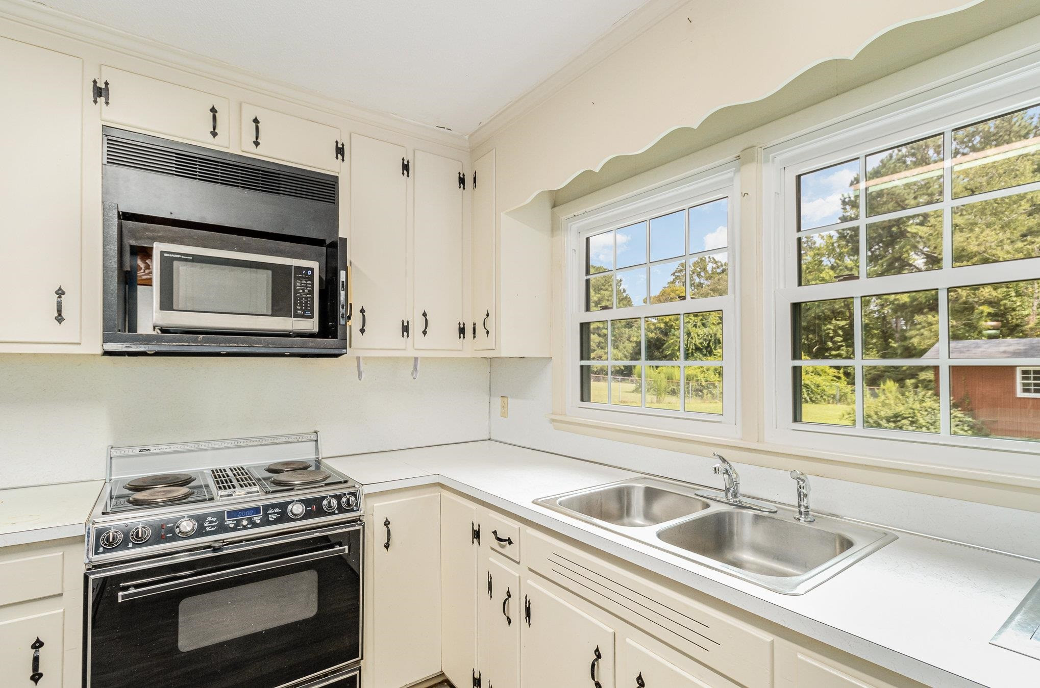 4800 Kyle Drive Raleigh, NC 27616 - Photo 25 of 36 a kitchen with granite countertop a sink stainless steel appliances wooden floor and a window