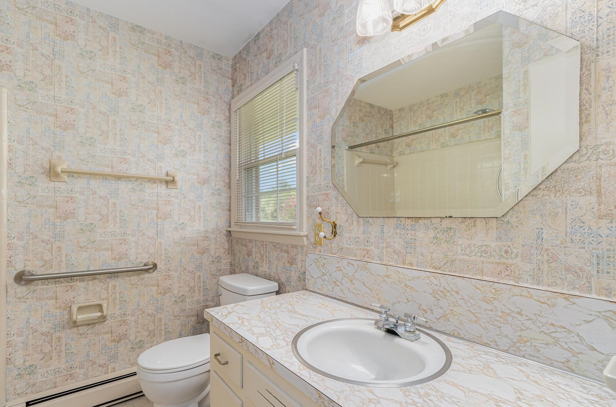 4800 Kyle Drive Raleigh, NC 27616 - Photo 28 of 36 a bathroom with a sink a toilet and shower