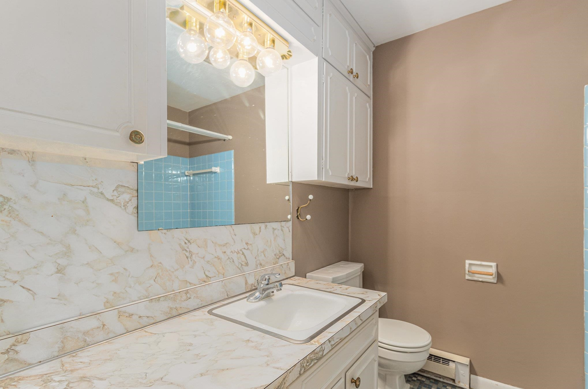 4800 Kyle Drive Raleigh, NC 27616 - Photo 29 of 36 a bathroom with a granite countertop toilet a sink and a mirror