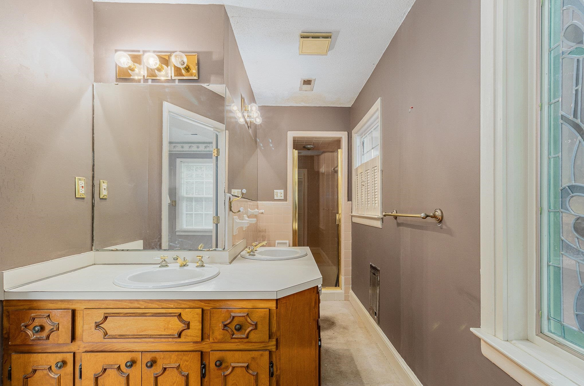 4800 Kyle Drive Raleigh, NC 27616 - Photo 33 of 36 a bathroom with a granite countertop sink a mirror and a shower