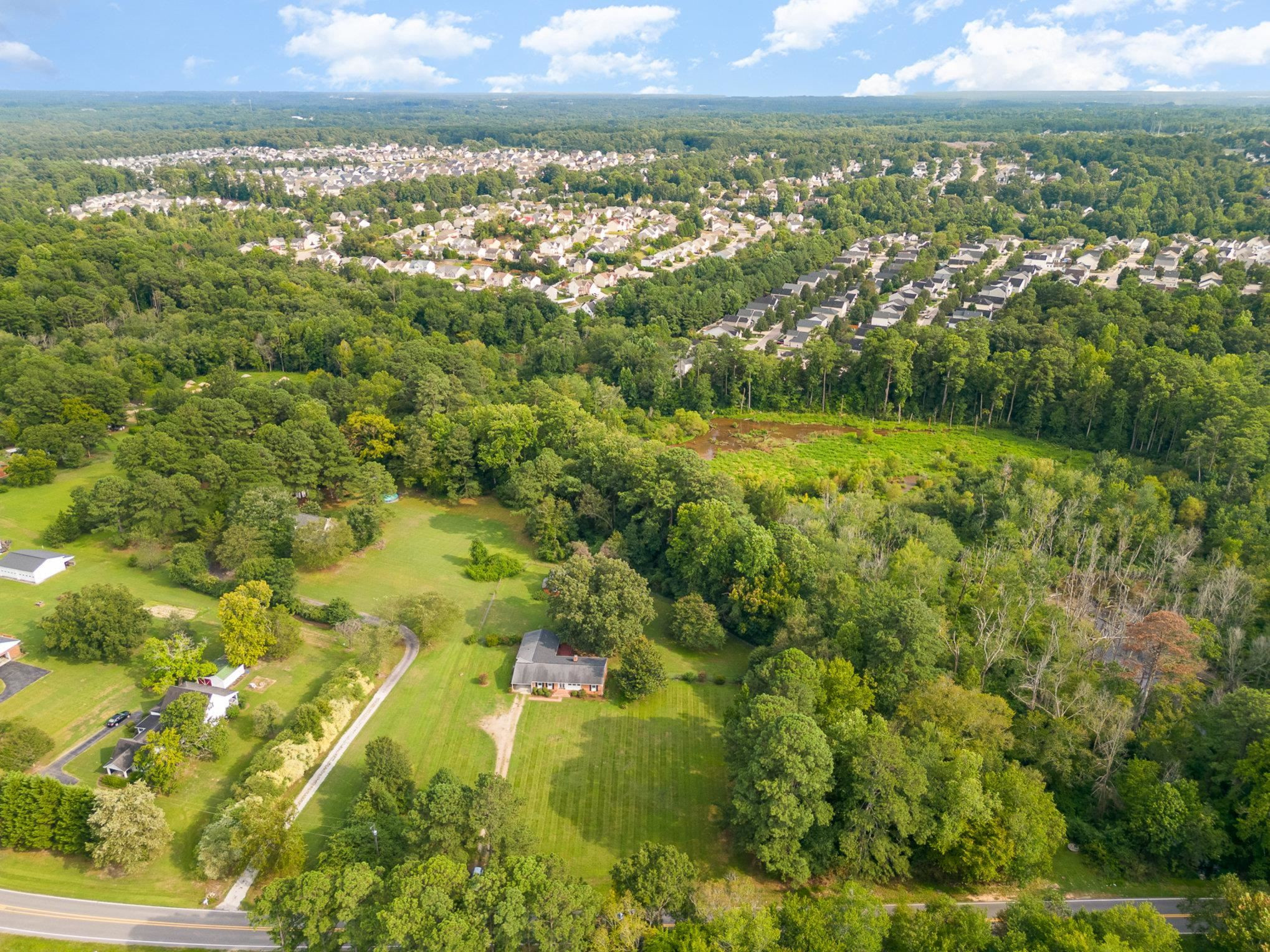4800 Kyle Drive Raleigh, NC 27616 - Photo 6 of 36 an aerial view of residential houses with outdoor space and trees