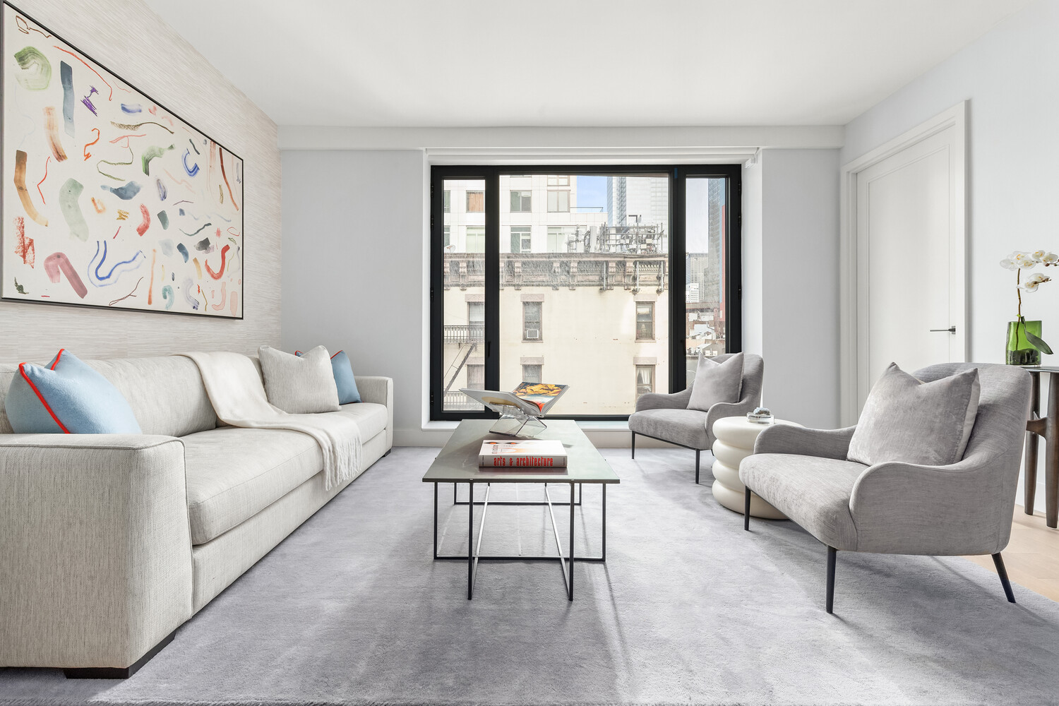 499 9th Avenue, Unit 5DN Manhattan, NY 10018 - Photo 3 of 8 a living room with furniture and large windows