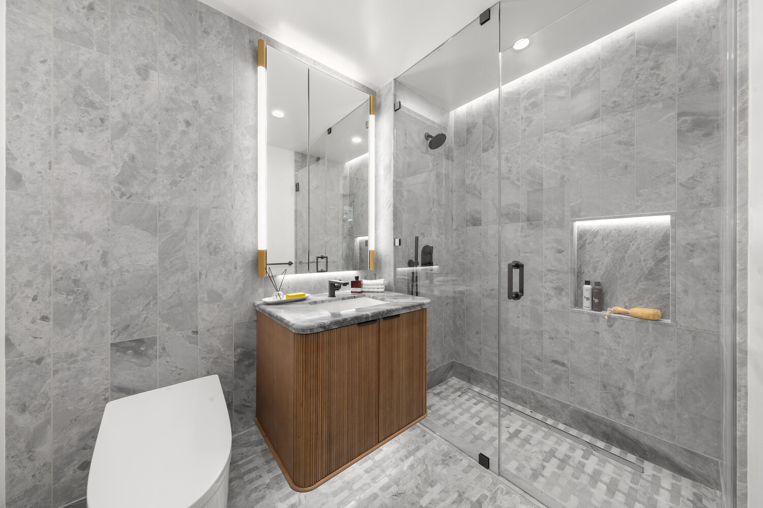 499 9th Avenue, Unit 5DN Manhattan, NY 10018 - Photo 4 of 8 a bathroom with a sink toilet and shower